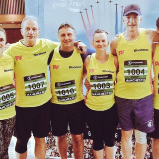 Casualty star George Rainsford with the running team. All 8 runners are wearing Bloodwise vests